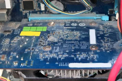The desktop is covered in dust. Dust on the computer board. Computer service  Stock Photos