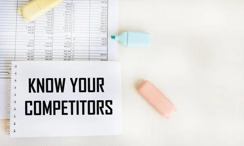 Desktop with documents, notepad with text Know Your Competitors Stock Photos