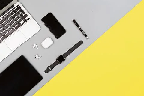 Desktop flat lay with laptop, mobile phone, wireless headphones. Colors of the Stock Photos