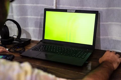 Desktop with gadgets like a mouse external HDDs, headsets, a cell phone and a Stock Photos