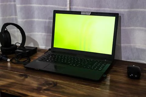 Desktop with gadgets like a mouse external HDDs, headsets, a cell phone and a Stock Photos