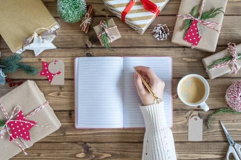 Desktop mock up planner. Flat lay of Woman s hands writes in a notebook and w Stock Photos