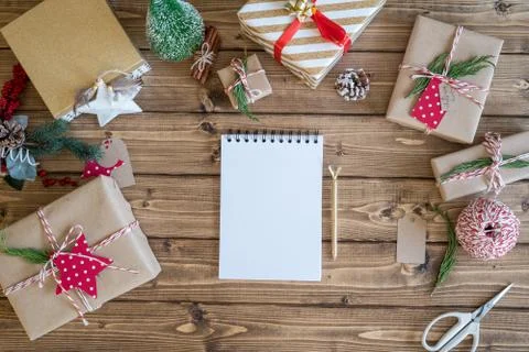 Desktop mock up planner. Flat lay of open notebook and wrapping Christmas gif Stock Photos