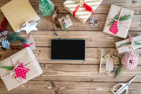 Desktop mock up planner. Flat lay of open notebook and wrapping Christmas gift Stock Photos