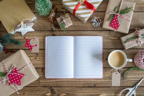 Desktop mock up planner. Flat lay of open notebook and wrapping Christmas gif Stock Photos
