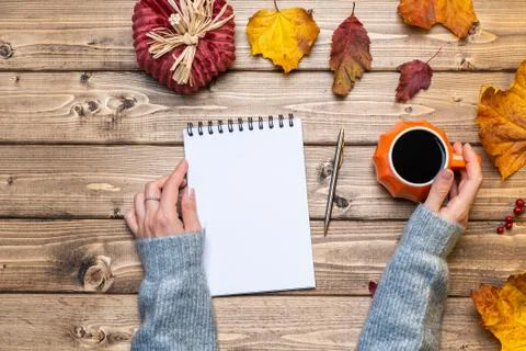 Desktop mock up planner. Top view composition with woman's hands in sweater,  Stock Photos