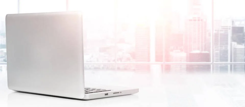 Desktop with panoramic view Laptop on table in office with panoramic view ... Stock Photos