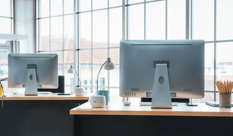 Desktop PC computers in small modern office or home office. Jivy Stock Photos