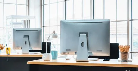 Desktop PC computers in small modern office or home office. Jivy Stock Photos