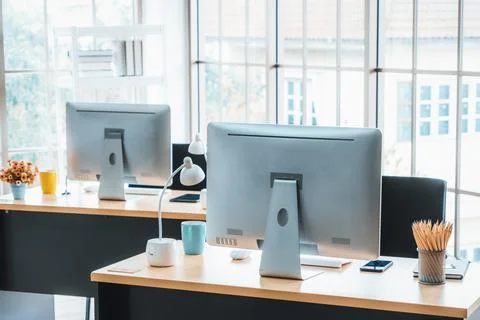 Desktop PC computers in small modern office or home office. Jivy Stock Photos