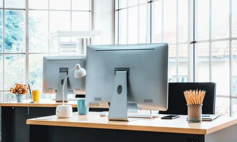 Desktop PC computers in small modern office or home office. Jivy Stock Photos