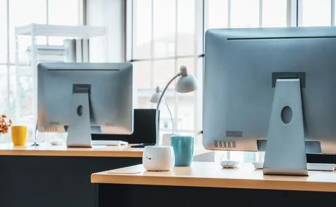 Desktop PC computers in small modern office or home office. Jivy Stock Photos