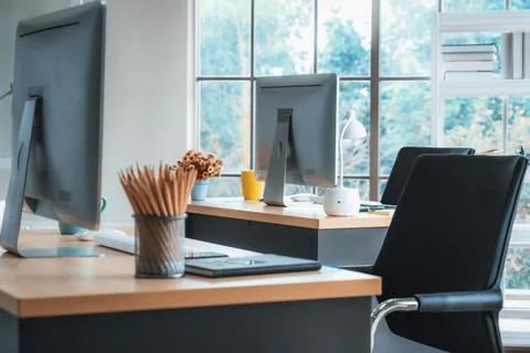 Desktop PC computers in small modern office or home office. Jivy Stock Photos