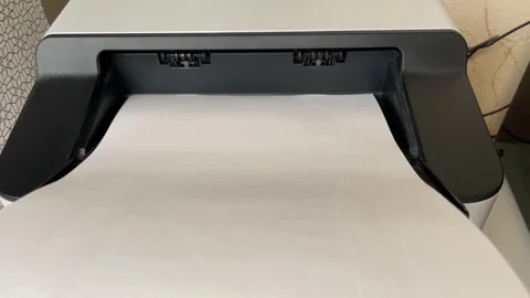 Desktop printer outputs paper pages in a steady feed,rollers moving the she.. Vidéo 331442290