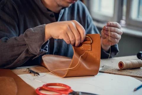 Desktop in the shoemaker workshop. The process of making leather shoes. Hands Stock Photos