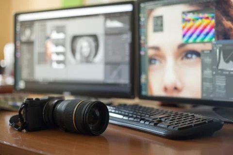 Desktop with two monitors, a keyboard, a camera, a diary, a palette for a des Stock Photos