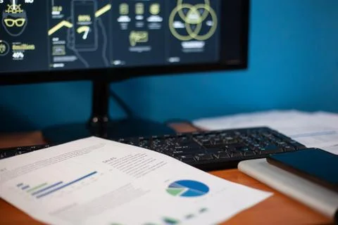 The desktop on which the printed chart is next to the keyboard and daily cale Stock Photos