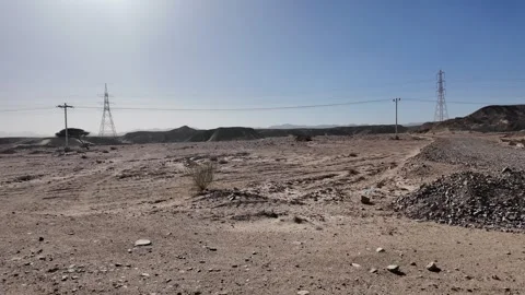 Desolate arid desert landscape with power lines in egypt Stock Footage 335998545