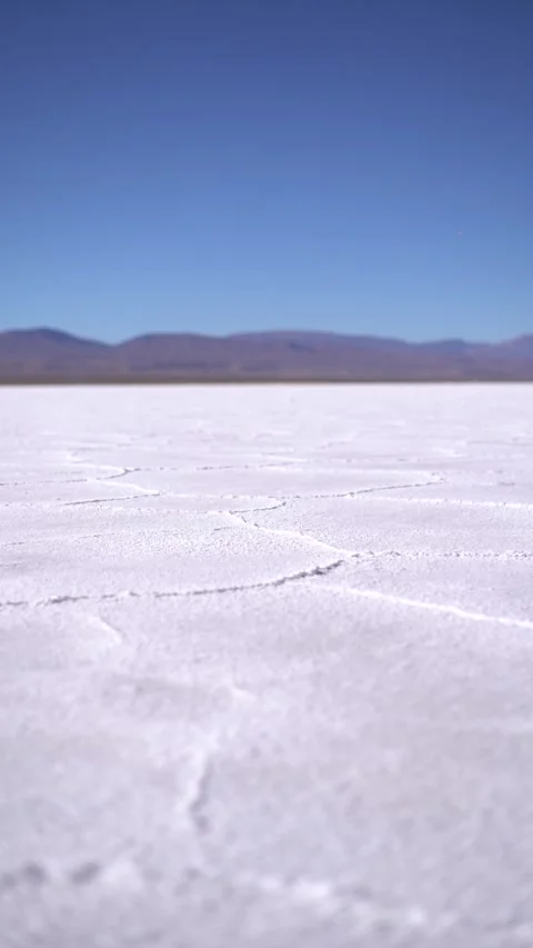 A desolate desert landscape with a blue sky in the background Stock Footage 329560546