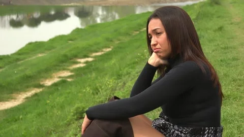 Desolate Gaze in Park: Young Cuban Woman Alone Stock Footage 262307381