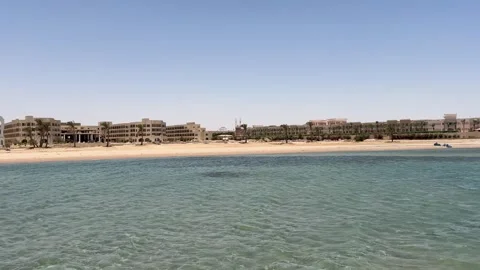 A desolate hotel by the Red Sea, its abandoned structure overlooking tranquil Stock Footage 282799134