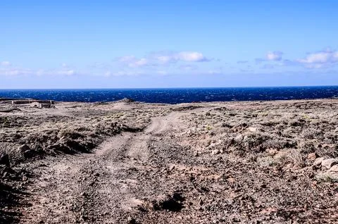 A desolate landscape with a blue ocean in the background Foto stock