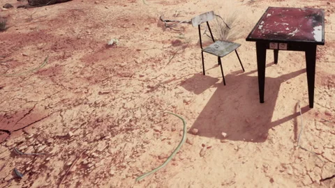 Desolate Landscape Features an Abandoned Table and Chair Under a Bright Sun Stock Footage 348494262