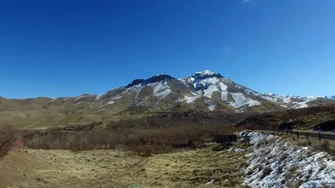 A desolate landscape with sparse dry bushes and scattered, stock footage. Stock Footage 304784732