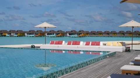 Desolate luxury holiday resort with empty sun loungers and parasols Stock Footage 132263846