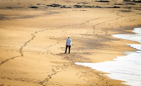 Desolate Man on Beach Stock Photos