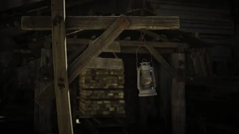 Desolate mining site illuminated by flickering lantern in wilderness Stock Footage 339625542