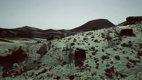 Desolate rocky ridge illuminated by soft twilight hues and dramatic silhouettes Video stock 343621952