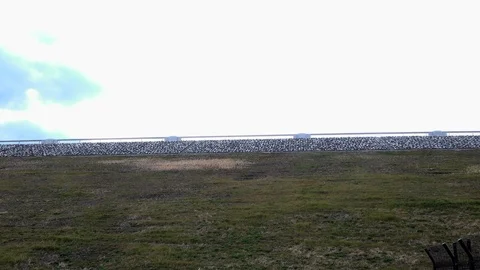 A desolate slope. Daytime. Side-way. Background bridge. Camera fix, angle Video stock 107002043