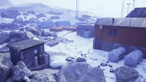 Desolate snowy harbor featuring rusted containers and distant equipment Video stock 341577276