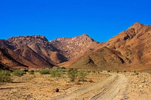 Desolate Valley with Red Hills Stock Photos
