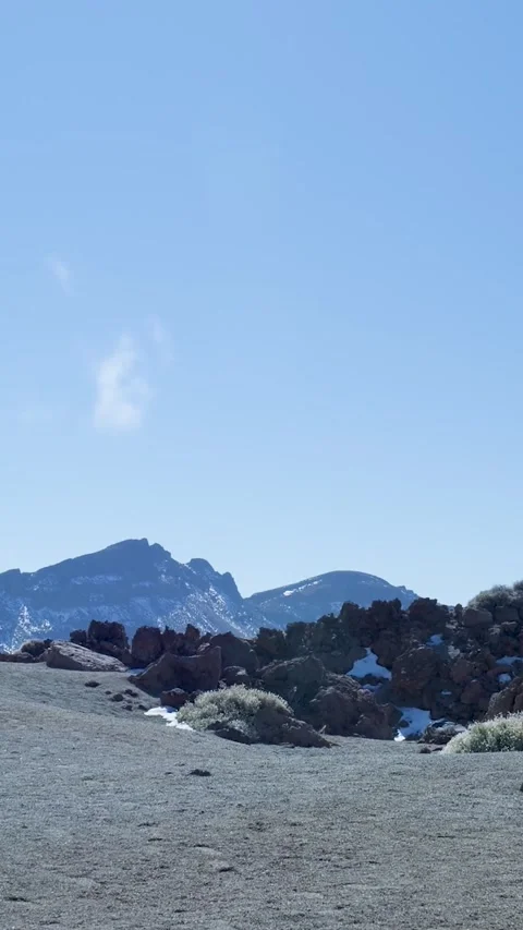 Desolate volcanic rock landscape with snowy mountains 库存影片 329865185
