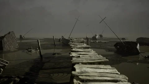 Desolate waterfront pathway. Weathered pier stretches across muddy inlet Stock Footage 341582748