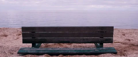 Desolate Winter Beach: Overturned Empty Bench Overlooking the Sea Stock Footage 260933488