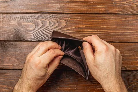 Despair over empty wallet reflects financial struggles and economic crisis Stock Photos