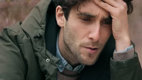 Despair, problems -desperate young man on the verge of tears smokes a cigarette  스톡 동영상 240338130