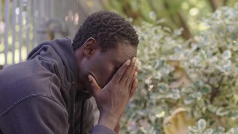 Despair, problems -worried black man on the street runs his hands over his face  Stock-Footage 231687461