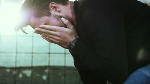 Despair, problems - young man in trouble sighs with his hands on his face Stock Footage 147356389
