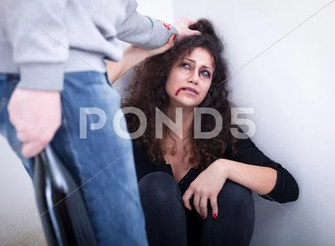 Despaired woman beaten by drunk man. concept of home violence Stock Photos