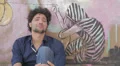 desperate and depressed young man sitting near a graffiti wall HD Footage