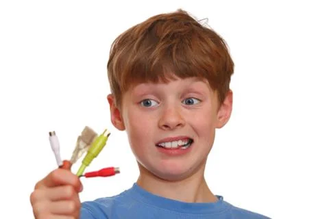 Desperate boy holds some computer wires Foto stock