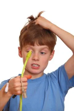 Desperate boy holds some computer wires Stock Photos