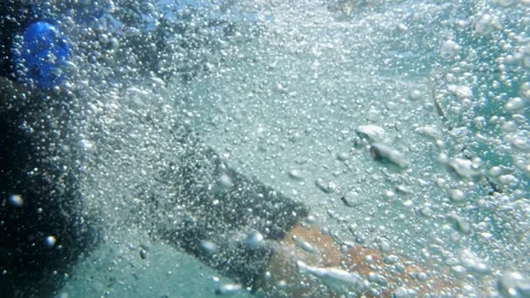 Desperate calls for help from a diver, slow-mo capture amidst a sea of bubble Stock Footage 249996547