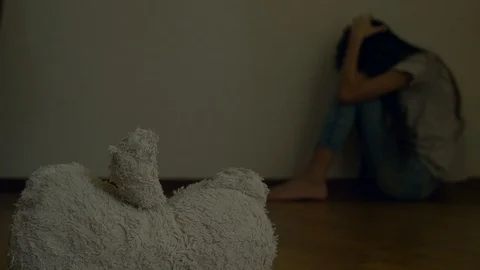 A desperate child in depression sits at the wall of his room, tries to attempt Stock Footage 87860705