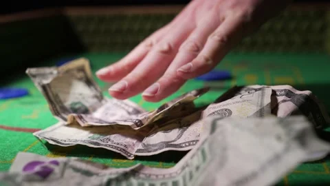Desperate crumpled money placed on craps table close up Stock Footage 153951238