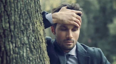 Desperate elegant man alone in a park Stock Footage 64732060